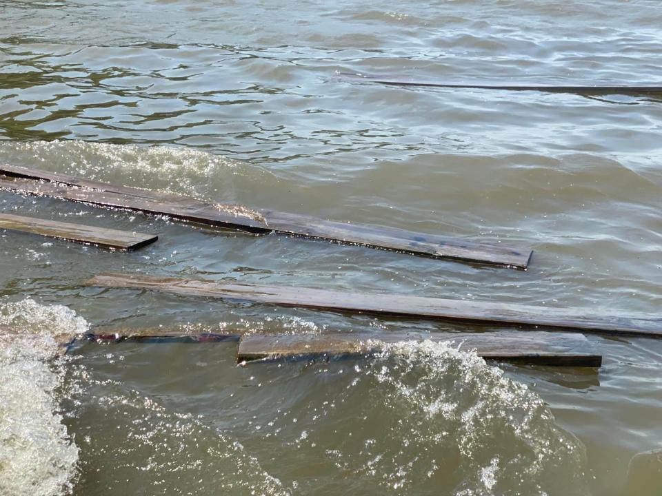 Debris floats on the Illinois River after a tugboat operated by Dick Hamm sunk north of the McClugage Bridge on Saturday, June 25, 2022.