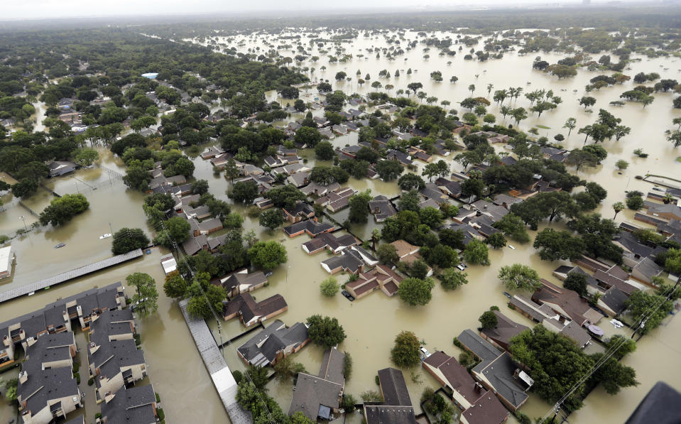 <p>Water from Addicks Reservoir flows into neighborhoods as floodwaters from Tropical Storm Harvey rise Tuesday, Aug. 29, 2017, in Houston. (Photo: David J. Phillip/AP) </p>