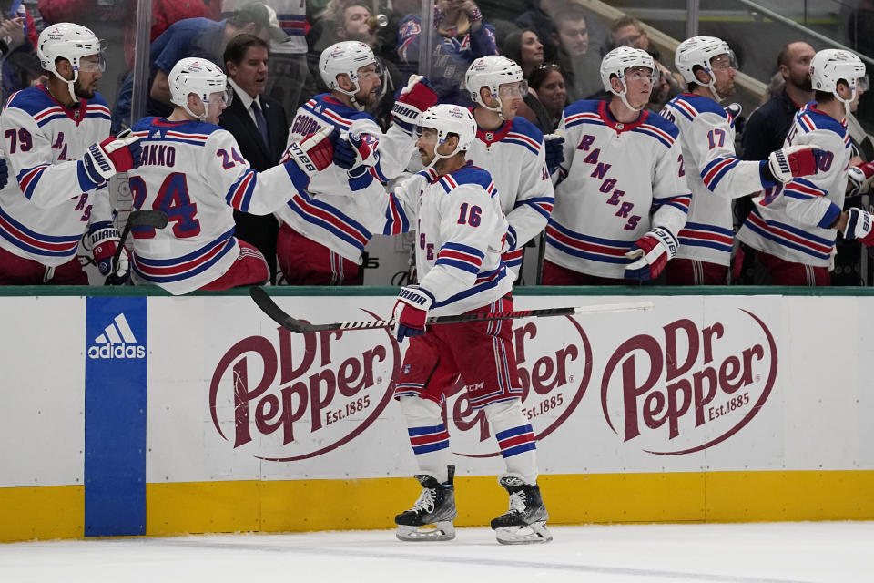 New York Rangers center Vincent Trocheck (16) celebrates with the bench after scoring in the first period of an NHL hockey game against the Dallas Stars in Dallas, Monday, Nov. 20, 2023. (AP Photo/Tony Gutierrez)