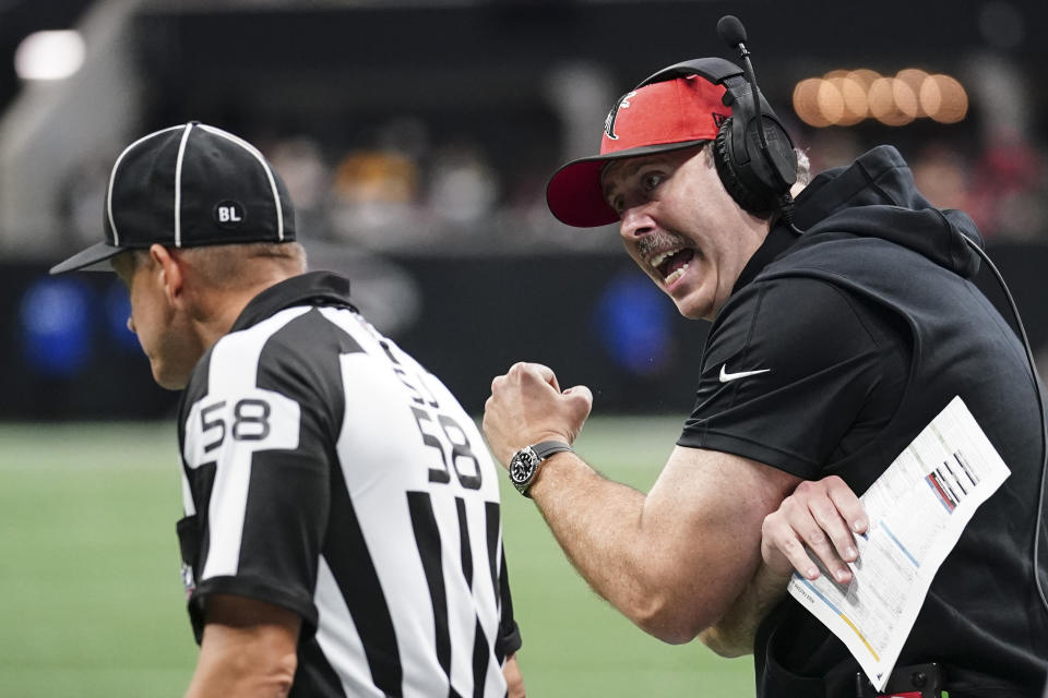 Atlanta Falcons head coach Arthur Smith speaks to side judge Don Willard (58) during the second half of an NFL football game against the Green Bay Packers, Sunday, Sept. 17, 2023, in Atlanta. (AP Photo/John Bazemore)