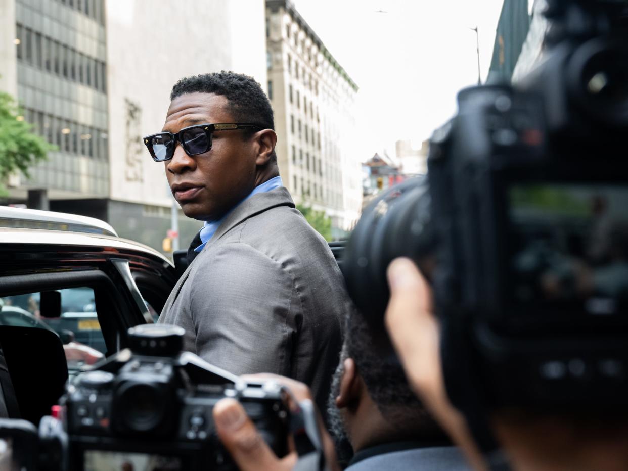 Jonathan Majors, looks backs at reporters while leaving Manhattan Criminal court after a pre-trial hearing in August 2023.
