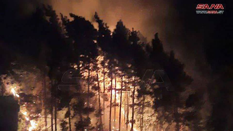 A photo released by Syrian state news agency SANA on Sunday, September 8, shows the Wadi al-Uyun highway in Masyaf, where a fire reportedly caused by Israeli airstrikes has broken out. - SANA