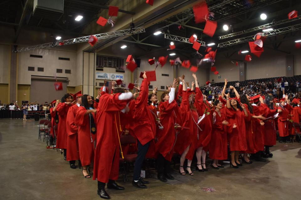 Ellender Memorial High School graduates toss their caps into the air after their commencement May 22, 2023, at the Barry Bonvillain Civic Center in Houma.