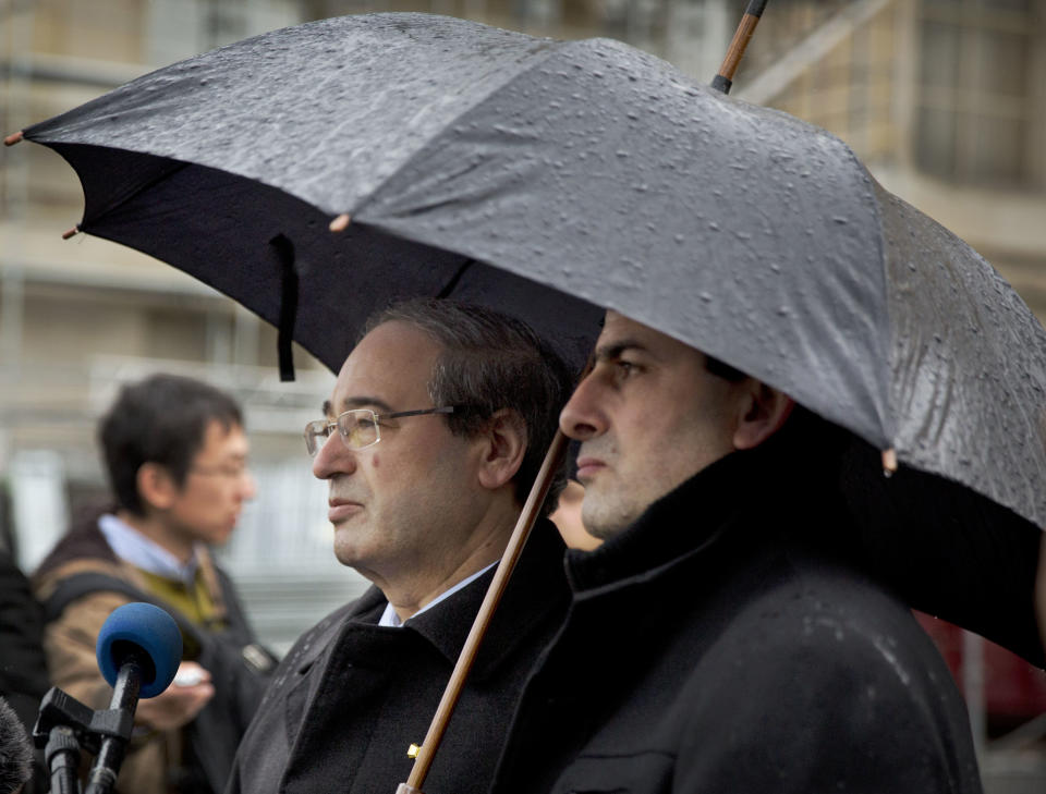 Syrian Deputy Foreign Minister Faisal Mekdad, center, waits with an aide to brief journalists at the United Nations headquarters in Geneva, Switzerland, Switzerland, Monday, Feb 10, 2014. Syrian government and opposition delegates began a fresh round of U.N.-brokered peace talks Monday, but prospects for common ground appeared unlikely as the two sides traded accusations over weekend violence that disrupted food distribution meant to ease the plight of civilians. (AP Photo/Anja Niedringhaus)