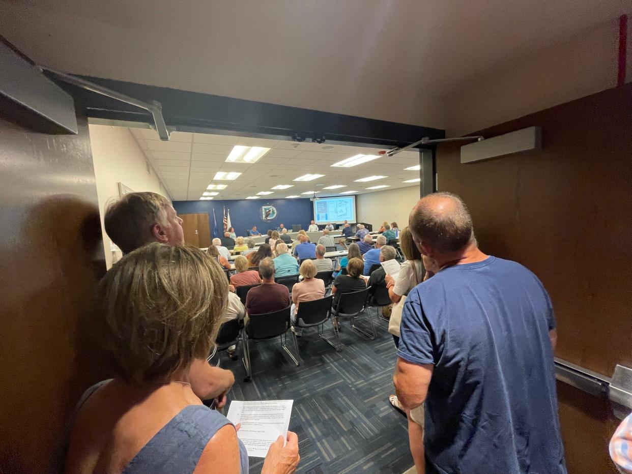 A crowd overflows into the lobby as the town of Delafield plan commission discusses the latest Thomas Farm development concepts on June 12.