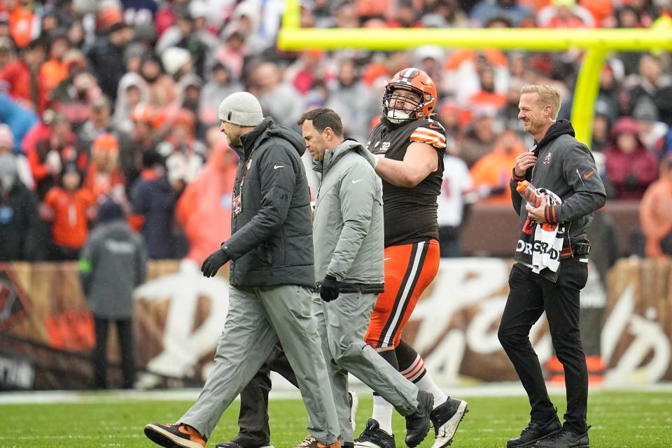 Browns guard Joel Bitonio is helped off the field after an injury in the first half against the Bears in Cleveland, Sunday, Dec. 17, 2023.