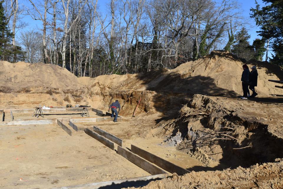 Casey Furnas, left, with LaBarge Homes and Jess Kimball and Sarah Kimball at the site on the homes they are building at 82 Monument Road in Orleans. They demolished an old home on the property and are building the new ones at cost that will allow them to stay on Cape Cod.