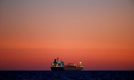 An oil tanker is seen at sunset anchored off the Fos-Lavera oil hub near Marseille, France, October 5, 2017. REUTERS/Jean-Paul Pelissier