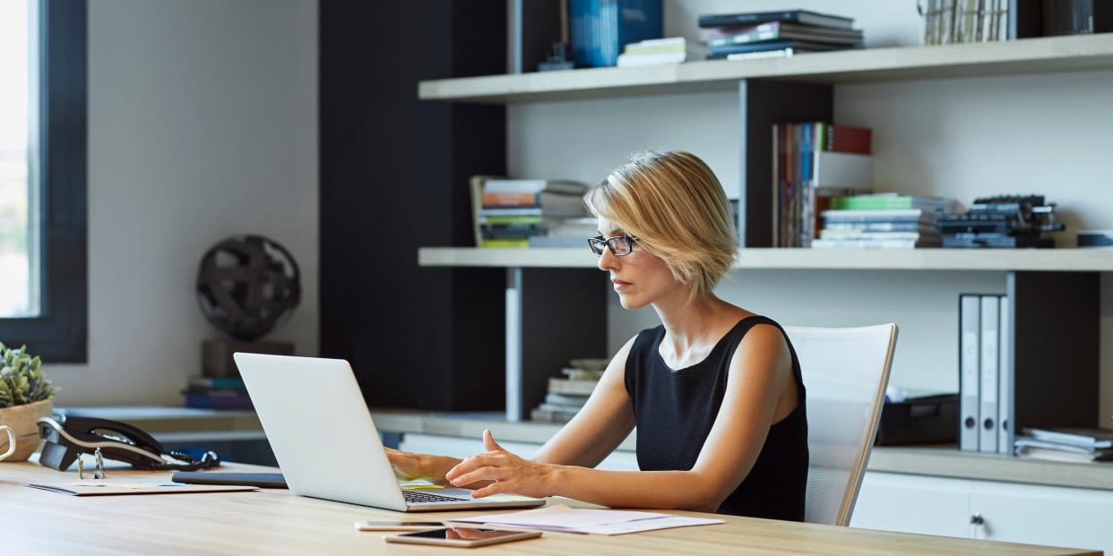 business professional using laptop in home office