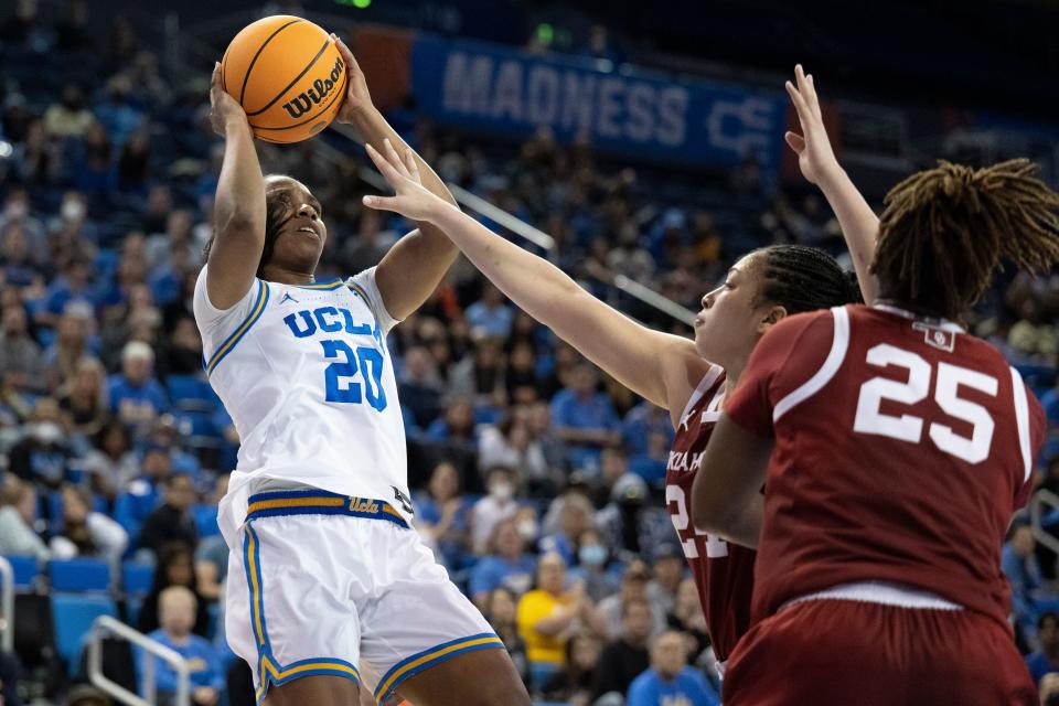 UCLA guard Charisma Osborne (20) shoots over Oklahoma guard Skylar Vann (24) during the second half of a second-round college basketball game in the NCAA Tournament, Monday, March 20, 2023, in Los Angeles. (AP Photo/Kyusung Gong)