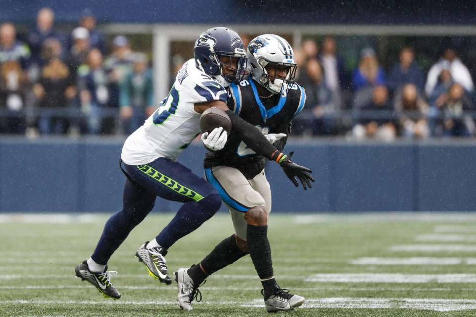 Sep 24, 2023; Seattle, Washington, USA; Seattle Seahawks cornerback Michael Jackson (30) breaks a up a pass intended for Carolina Panthers running back Miles Sanders (6) during the fourth quarter at Lumen Field. Mandatory Credit: Joe Nicholson-USA TODAY Sports