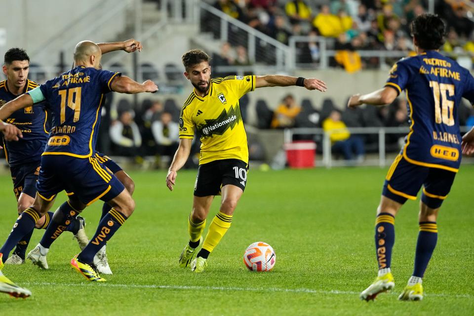 Apr 2, 2024; Columbus, OH, USA; Columbus Crew forward Diego Rossi (10) dribbles between Tigres UANL midfielder Guido Pizarro (19) and midfielder Diego Lainez (16) during the second half of the Concacaf Champions Cup quarterfinal at Lower.com Field. The game ended in a 1-1 tie. Mandatory Credit: Adam Cairns-USA TODAY Sports