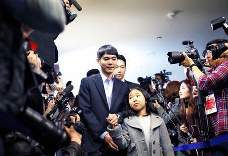 The world’s top Go player Lee Sedol walks with his daughter Lee Hye-lim as he heads for the venue of the last match of the Google DeepMind Challenge Match against Google's artificial intelligence program AlphaGo in Seoul, South Korea, March 15, 2016. REUTERS/Kim Hong-Ji