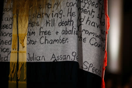 A model presents a creation adorned with a message regarding Julian Assange during the Vivienne Westwood catwalk show at London Fashion Week Women's A/W19 in London, Britain February 17, 2019. REUTERS/Henry Nicholls