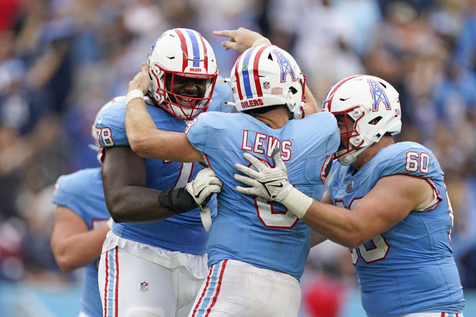 Tennessee Titans quarterback Will Levis (8) celebrates with Tennessee Titans offensive tackles Nicholas Petit-Frere (78) and Daniel Brunskill (60) after throwing a touchdown pass against the Atlanta Falcons during the second half of an NFL football game, Sunday, Oct. 29, 2023, in Nashville, Tenn. (AP Photo/George Walker IV)