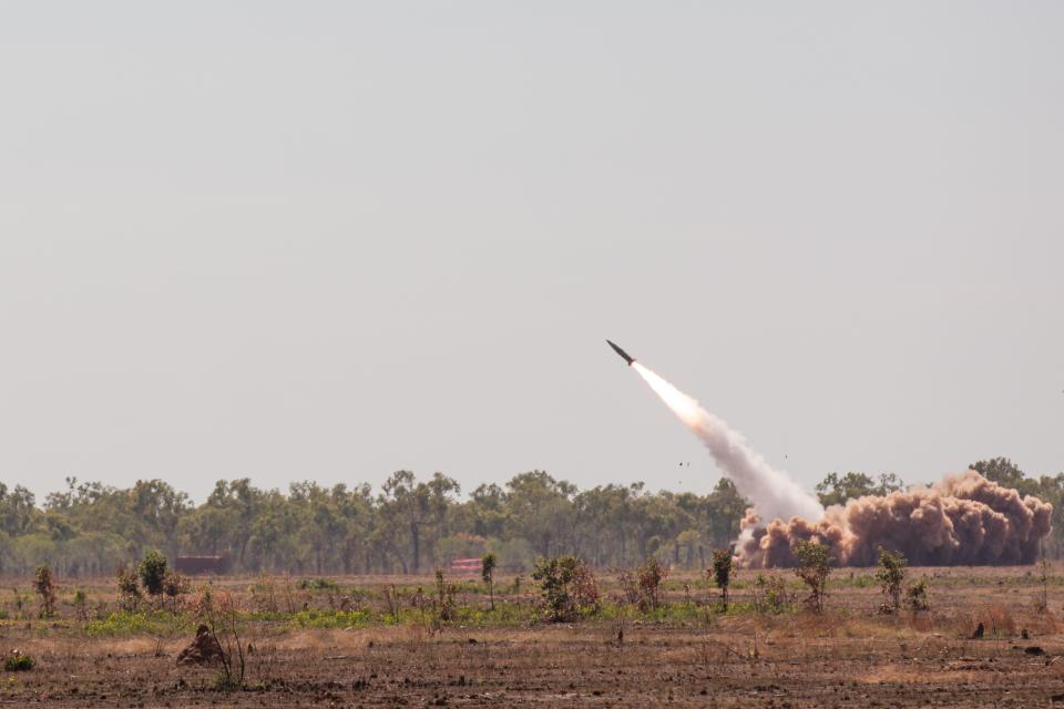 An Army Tactical Missile System is fired into the sky from the barren ground in Australia.