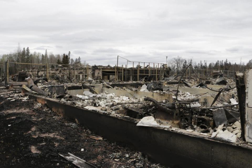 Destroyed townhouses in the Abasand neighborhood of Fort McMurray, Alberta, are viewed after a massive wildfire, Monday, May 9, 2016. (AP Photo/Rachel La Corte)