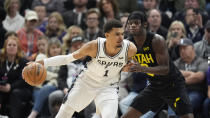 Utah Jazz forward Taylor Hendricks, right, guards San Antonio Spurs center Victor Wembanyama (1) during the first half of an NBA basketball game Wednesday, March 27, 2024, in Salt Lake City. (AP Photo/Rick Bowmer)