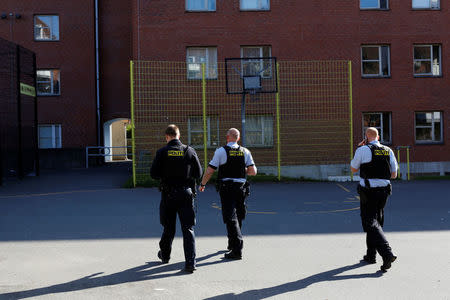 Police patrol the grounds in Mjolnerparken, a housing estate that features on the Danish government's "Ghetto List", in Copenhagen, Denmark, May 2, 2018. REUTERS/Andrew Kelly