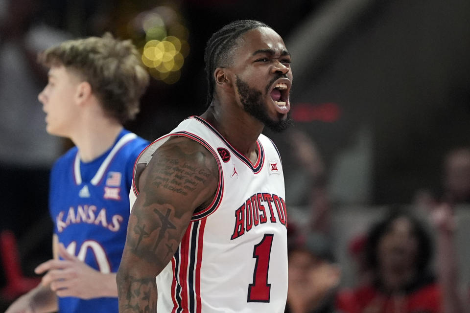 Houston's Jamal Shead (1) celebrates after making a 3-point basket against Kansas during the first half of an NCAA college basketball game Saturday, March 9, 2024, in Houston. (AP Photo/David J. Phillip)
