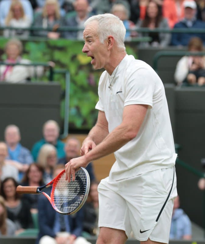 John Mcenroe plays an exhibition doubles match at the opening of Wimbledon’s new No.1 court on May 19. On January 21, 1990, McEnroe became the first player to be disqualified from the Australian Open after an outburst in which he broke his racquet. File Photo by Hugo Philpott/UPI