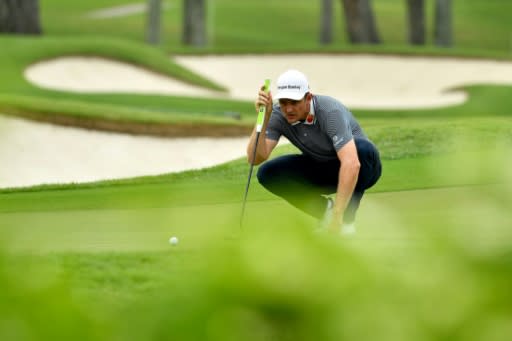 Justin Rose of England lining up a putt at the Singapore Open