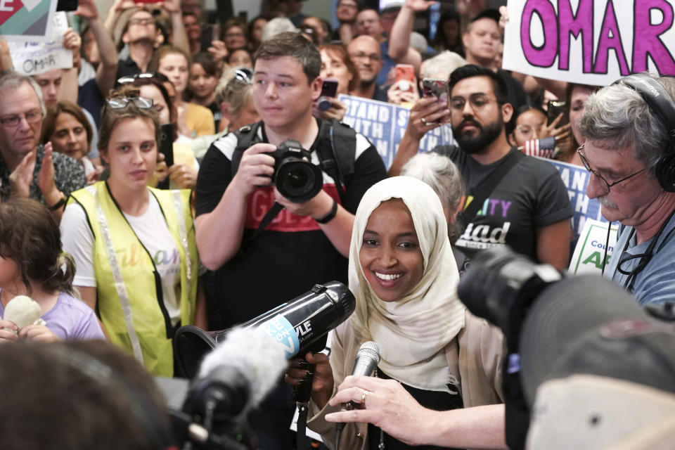 U.S. Rep. Ilhan Omar speaks to supporters as she arrives at Minneapolis–Saint Paul International Airport, Thursday, July 18, 2019, in Minnesota. President Donald Trump is chiding campaign supporters who'd chanted "send her back" about Somali-born Omar, whose loyalty he's challenged. (Glen Stubbe/Star Tribune via AP)