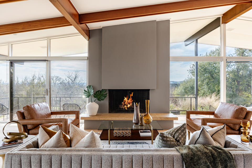 Inside the light-filled living room with a fireplace at 3403 Mountain Top Cir in Austin, TX.