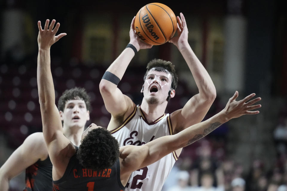 Boston College forward Quinten Post takes a shot as Clemson guard Chase Hunter tries to block during the second half of an NCAA college basketball game, Tuesday, Jan. 31, 2023, in Boston. (AP Photo/Charles Krupa)