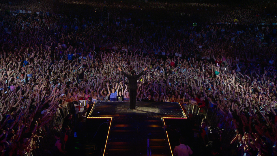 Robbie Williams performing on stage