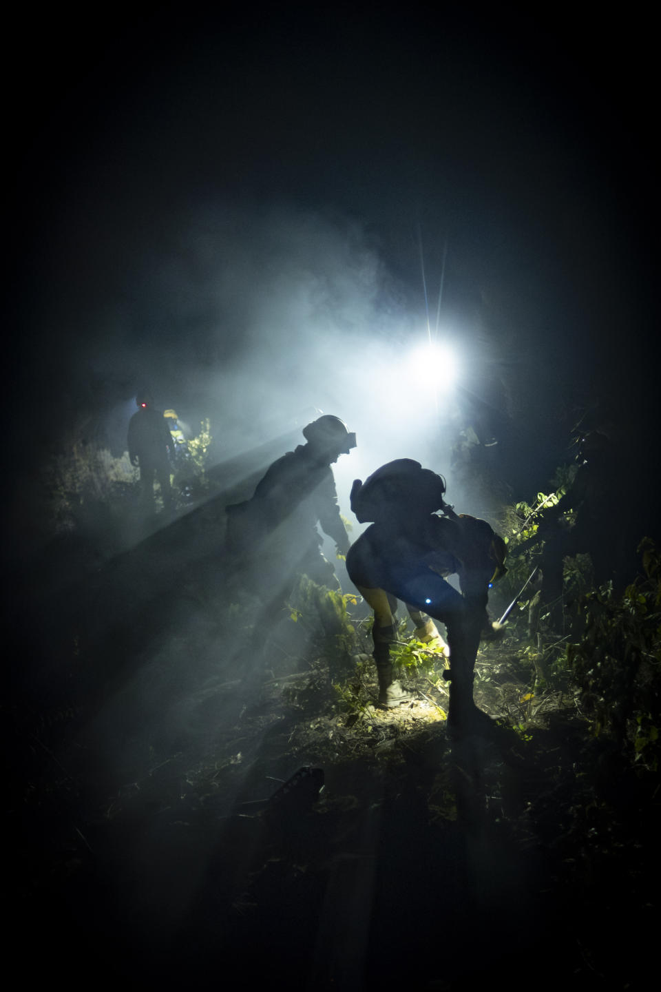 Emergency crews and firefighters are working to extinguish the fire advancing through the forest near the town of El Rosario in Tenerife, Canary Islands, Spain on Friday, Aug. 18, 2023. Officials say a wildfire is burning out of control through the Spanish Canary Island of Tenerife, affecting nearly 8,000 people who have been evacuated or ordered to stay indoors. (AP Photo/Arturo Rodriguez)