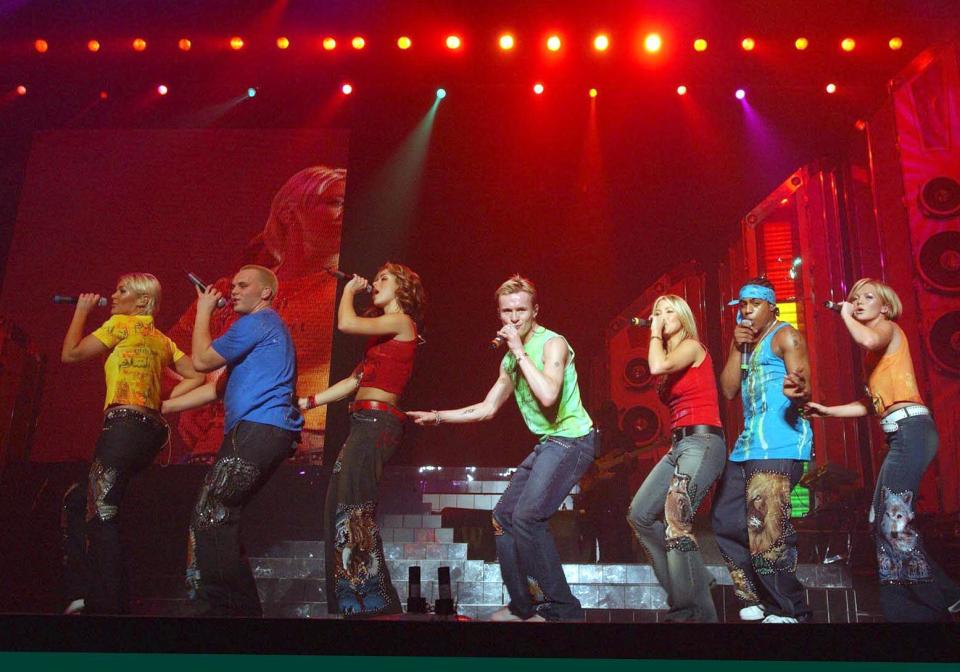 Pop group S Club 7, from left to right; Jo, Paul, Tina, Jon, Rachel, Bradley and Hannah, perform on stage at Wembley Arena in London. The gig is the first of three nights here, on the London stint of their UK tour.