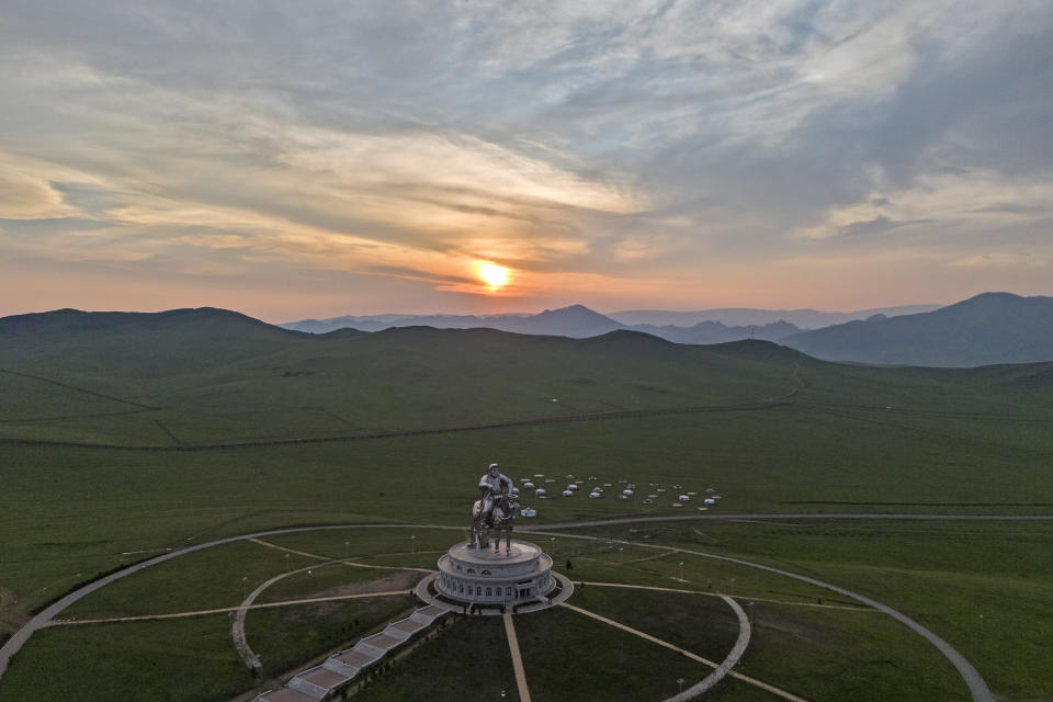 The sun sets over a 40-meter- (130-foot-) tall stainless steel statue of Genghis Khan, a national hero who amassed power to become the leader of the Mongols in the early 13th century on the outskirts of Ulaanbaatar, Mongolia, Monday, July 1, 2024. (AP Photo/Ng Han Guan)