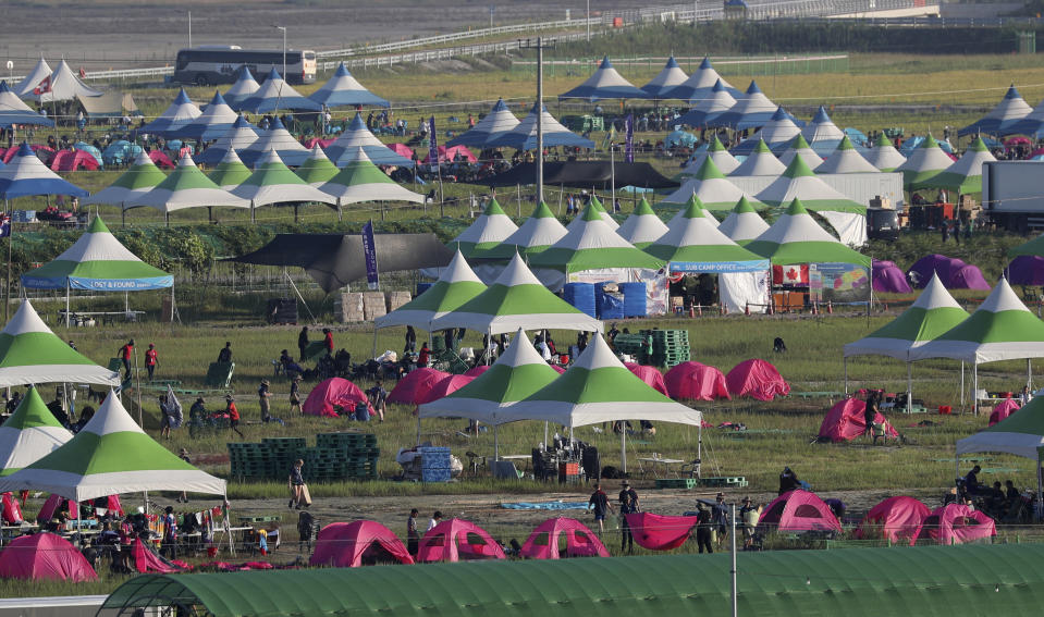 Attendees of the World Scout Jamboree prepare to leave a scout camping site in Buan, South Korea, Tuesday, Aug. 8, 2023. South Korea will evacuate tens of thousands of scouts by bus from a coastal jamboree site as Tropical Storm Khanun looms, officials said Monday. (Kim Myung-nyeon/Newsis via AP)