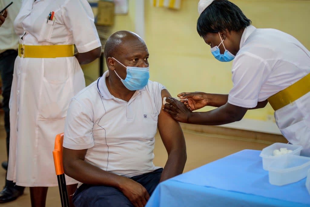 A nurse vaccinates a man against the coronavirus at St. Mary’s Hospital Lacor in Gulu, Uganda (AP)