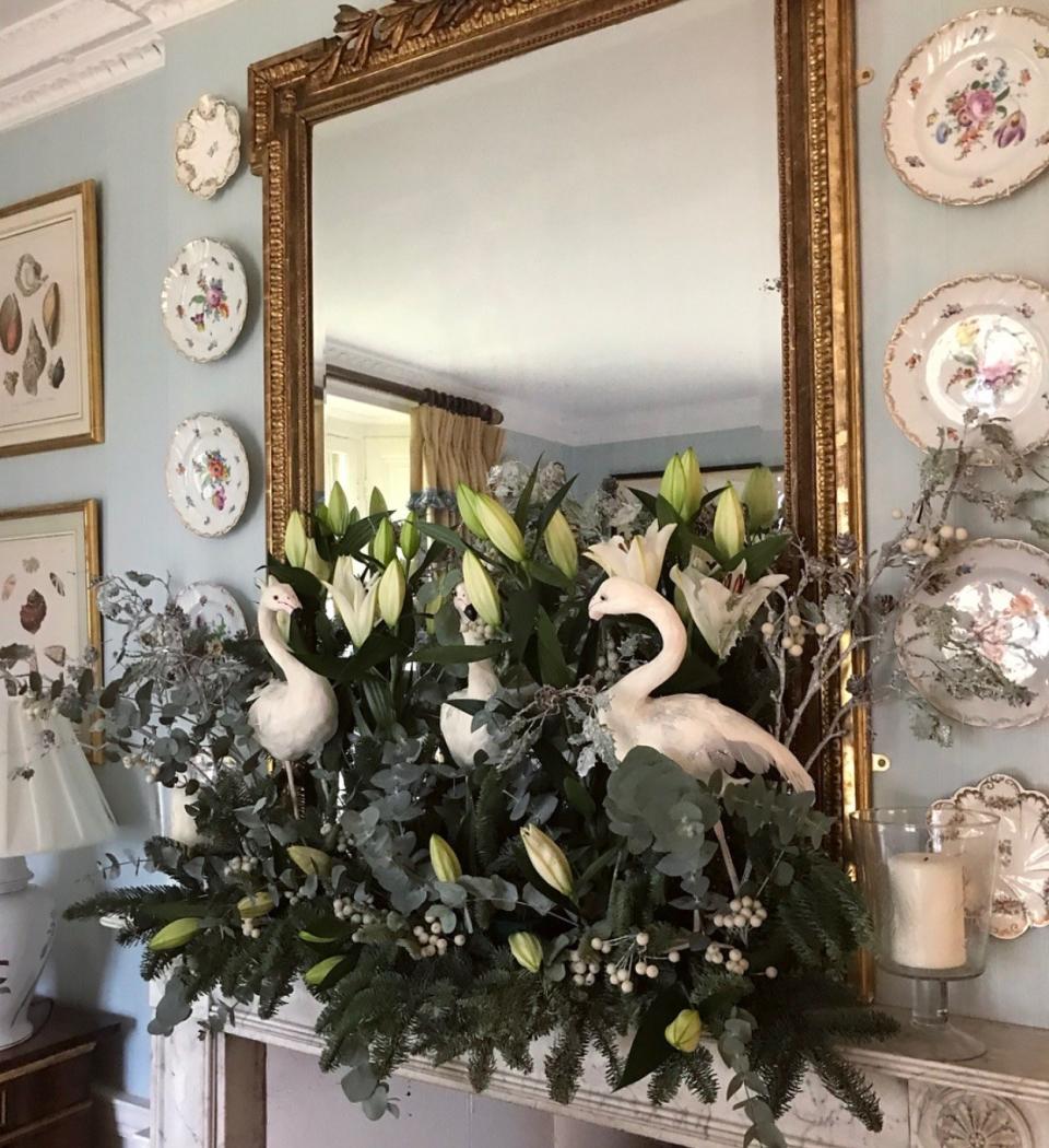 Our feathered friends perch pride of place in the dining room surrounded by lilies, berries, and crisp eucalyptus.