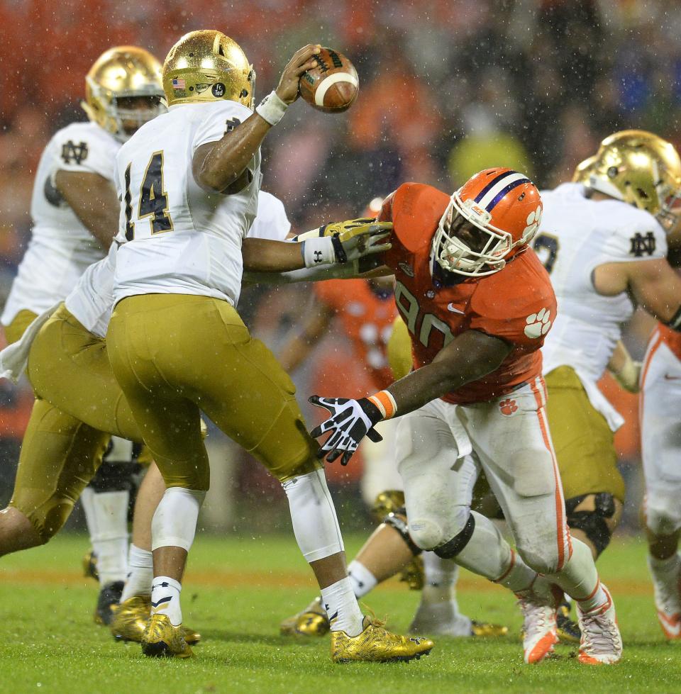 Clemson defensive end Shaq Lawson (90) pressures Notre Dame quarterback DeShone Kizer (14) during a game on Oct. 3, 2015. Lawson is among several former Clemson athletes who are advisors for the new NIL collective Dear Old Clemson LLC.