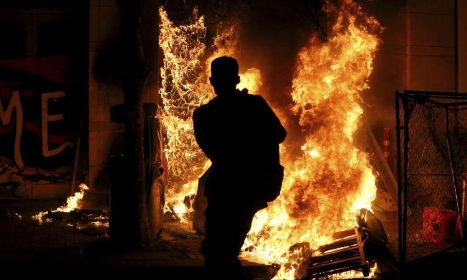 Protesters lit a portable bathroom on fire in downtown Portland, 16 April 2021.