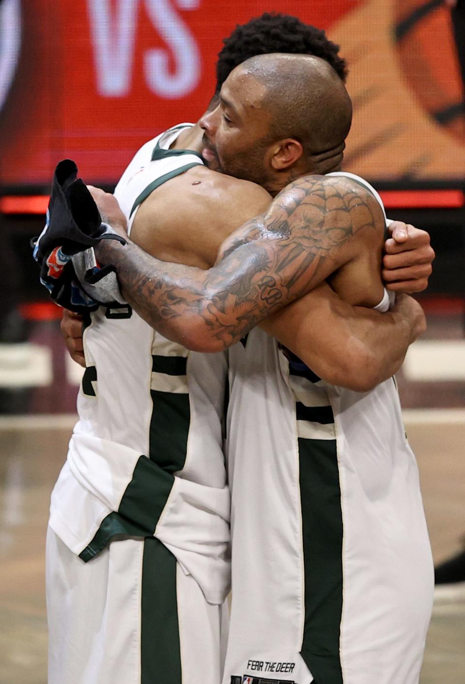 Giannis Antetokounmpo (left) and P.J. Tucker of the Milwaukee Bucks celebrate the win after game seven of the Eastern Conference second round at Barclays Center on June 19, 2021 in Brooklyn.