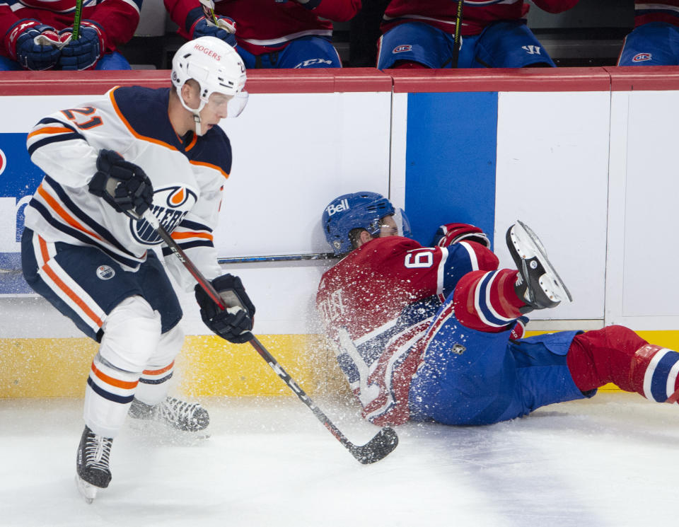 Montreal Canadiens' Xavier Ouellet is upended by Edmonton Oilers' Dominik Kahun (21) during the first period of an NHL hockey game, Wednesday, May 12, 2021 in Montreal. (Ryan Remiorz/Canadian Press via AP)