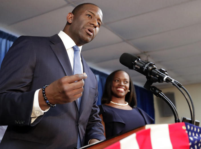 Florida Democratic gubernatorial candidate Andrew Gillum, left, speaks to supporters as his wife R. Jai Gillum listens during a Democratic Party rally Friday, Aug. 31, 2018, in Orlando, Fla. (AP Photo/John Raoux)