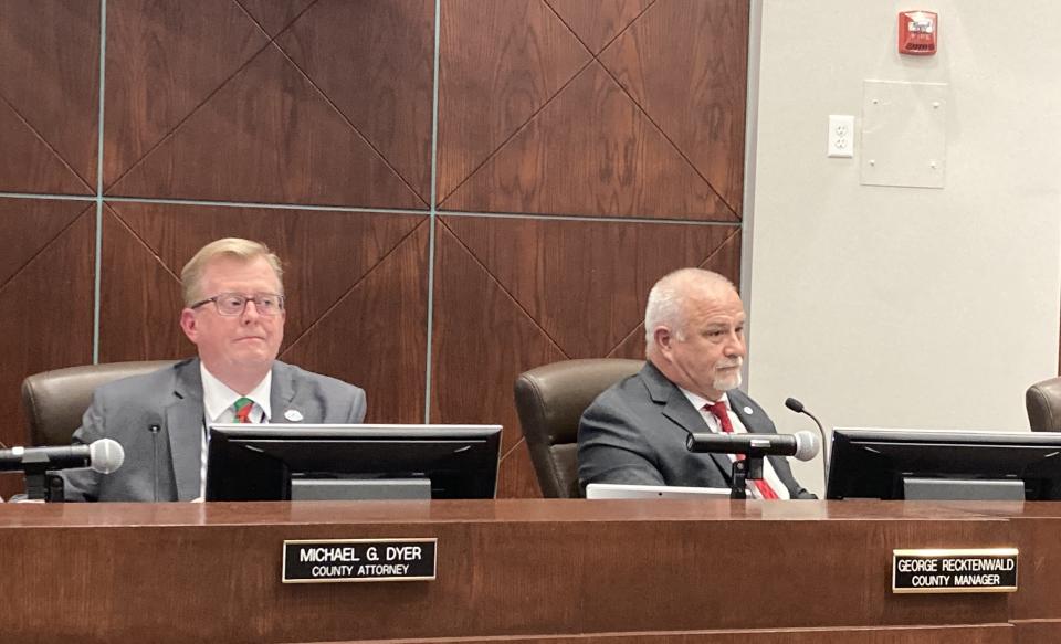 County Attorney Mike Dyer and County Manager George Recktenwald watch from their seats at the dais during Tuesday's Volusia County Council meeting.