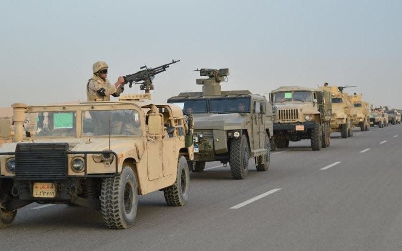 Egyptian Army's Armoured Vehicles are seen on a highway to North Sinai during a launch of a major assault against militants, in Ismailia - REUTERS