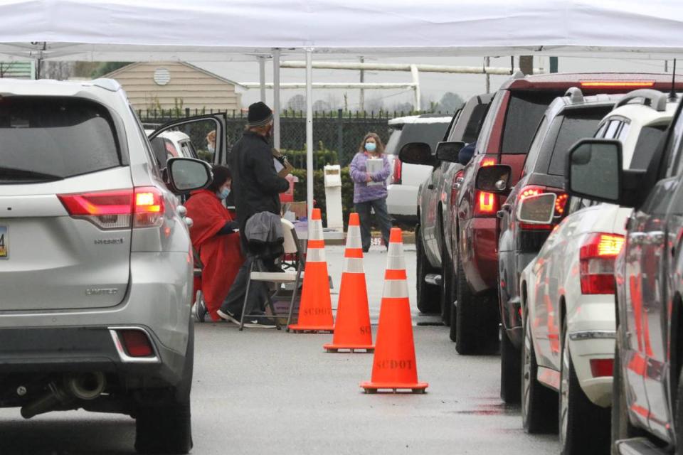 People wait in line on Friday, Jan. 15, 2021 to receive the Coronavirus vaccine at a mobile site at Gamecock Park in Columbia.