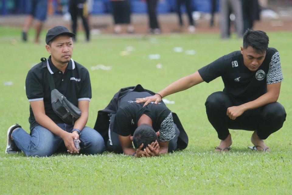 Arema FC players and officials react as they visit Kanjuruhan Stadium (via REUTERS)