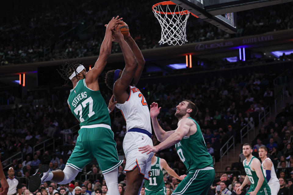 Oct 9, 2023; New York, New York, USA; New York Knicks center <a class="link " href="https://sports.yahoo.com/nba/players/6047" data-i13n="sec:content-canvas;subsec:anchor_text;elm:context_link" data-ylk="slk:Mitchell Robinson;sec:content-canvas;subsec:anchor_text;elm:context_link;itc:0">Mitchell Robinson</a> (23) drives to the basket as Boston Celtics forward Lamar Stevens (77) and center <a class="link " href="https://sports.yahoo.com/nba/players/5903" data-i13n="sec:content-canvas;subsec:anchor_text;elm:context_link" data-ylk="slk:Luke Kornet;sec:content-canvas;subsec:anchor_text;elm:context_link;itc:0">Luke Kornet</a> (40) defend during the second half at Madison Square Garden. Mandatory Credit: Vincent Carchietta-USA TODAY Sports