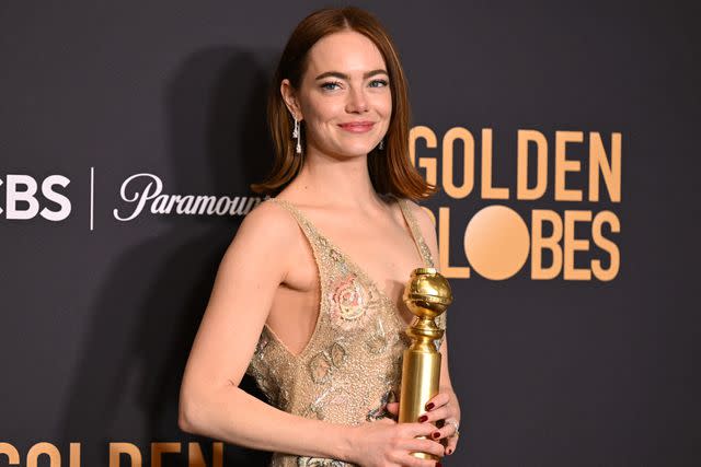 <p>ROBYN BECK/AFP via Getty</p> Emma Stone poses with the award for Best Performance by a Female Actor in a Motion Picture - Musical or Comedy for "Poor Things" in the press room during the 81st annual Golden Globe Awards at The Beverly Hilton hotel in Beverly Hills, California, on January 7, 2024