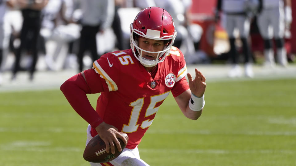 Kansas City Chiefs quarterback Patrick Mahomes runs the ball against the Las Vegas Raiders during the first half of an NFL football game, Sunday, Oct. 11, 2020, in Kansas City. (AP Photo/Charlie Riedel)