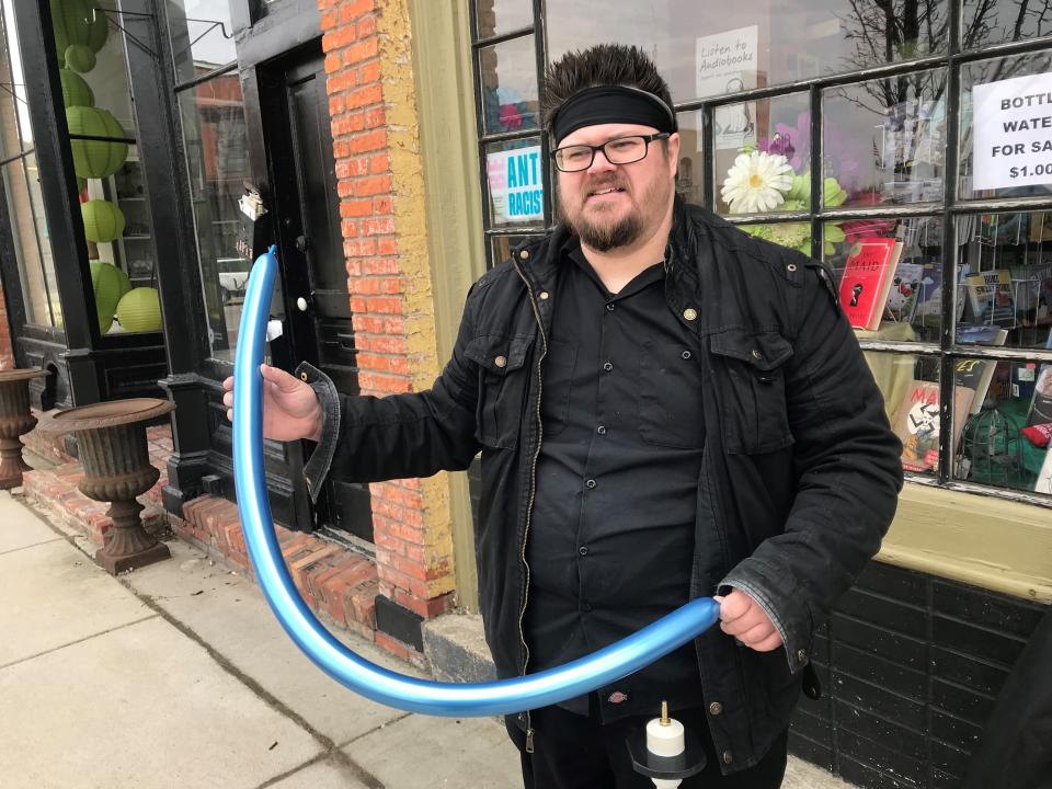 Steve Schniers, who made balloon animals outside of Fenton's Open Book store on Independent Bookstore Day April 30, says inflation is driving up the cost of balloons, as well as interest rates on his credit cards.