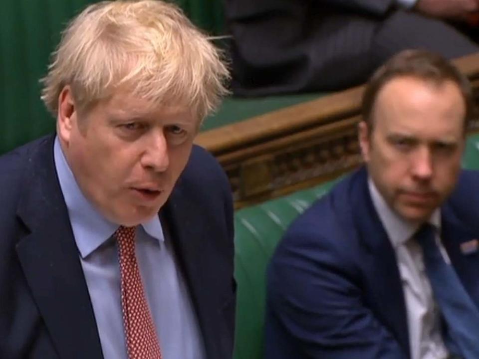 Britain's Health Secretary Matt Hancock (R) listening as Britain's Prime Minister Boris Johnson speaks: PRU/AFP via Getty Images